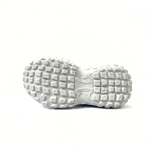 White textured sole of a kids slip-on shoe with geometric tread pattern