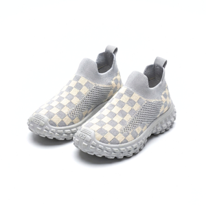 Light gray and cream checkered knit kids slip-on sneakers with textured soles