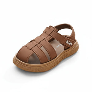 Brown kids summer slide sandal with closed toe and adjustable strap on white background