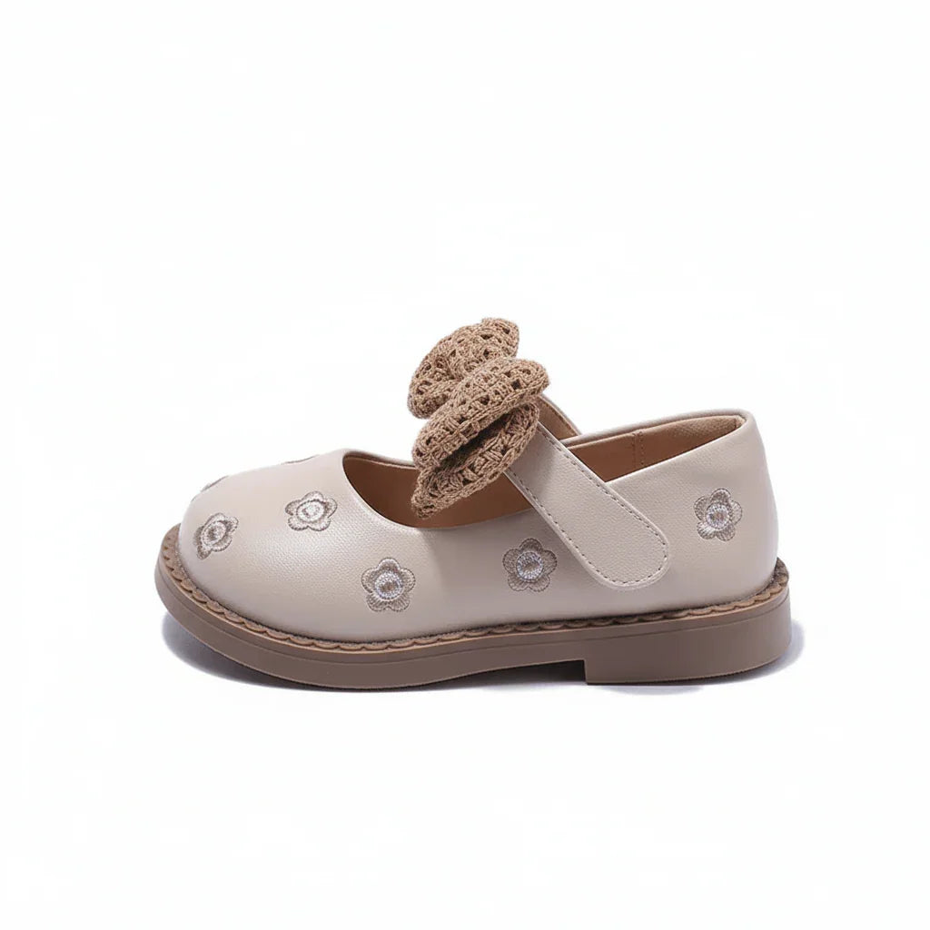 Beige baby girl shoe with floral embroidery and knitted bow strap, flat sole design