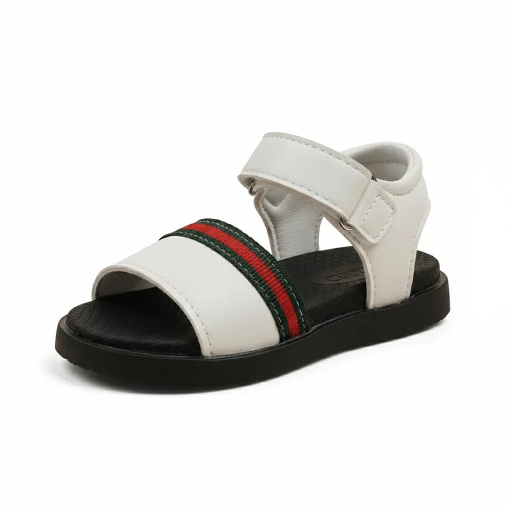 White kids sandal with black sole and red-green striped strap, adjustable Velcro closure