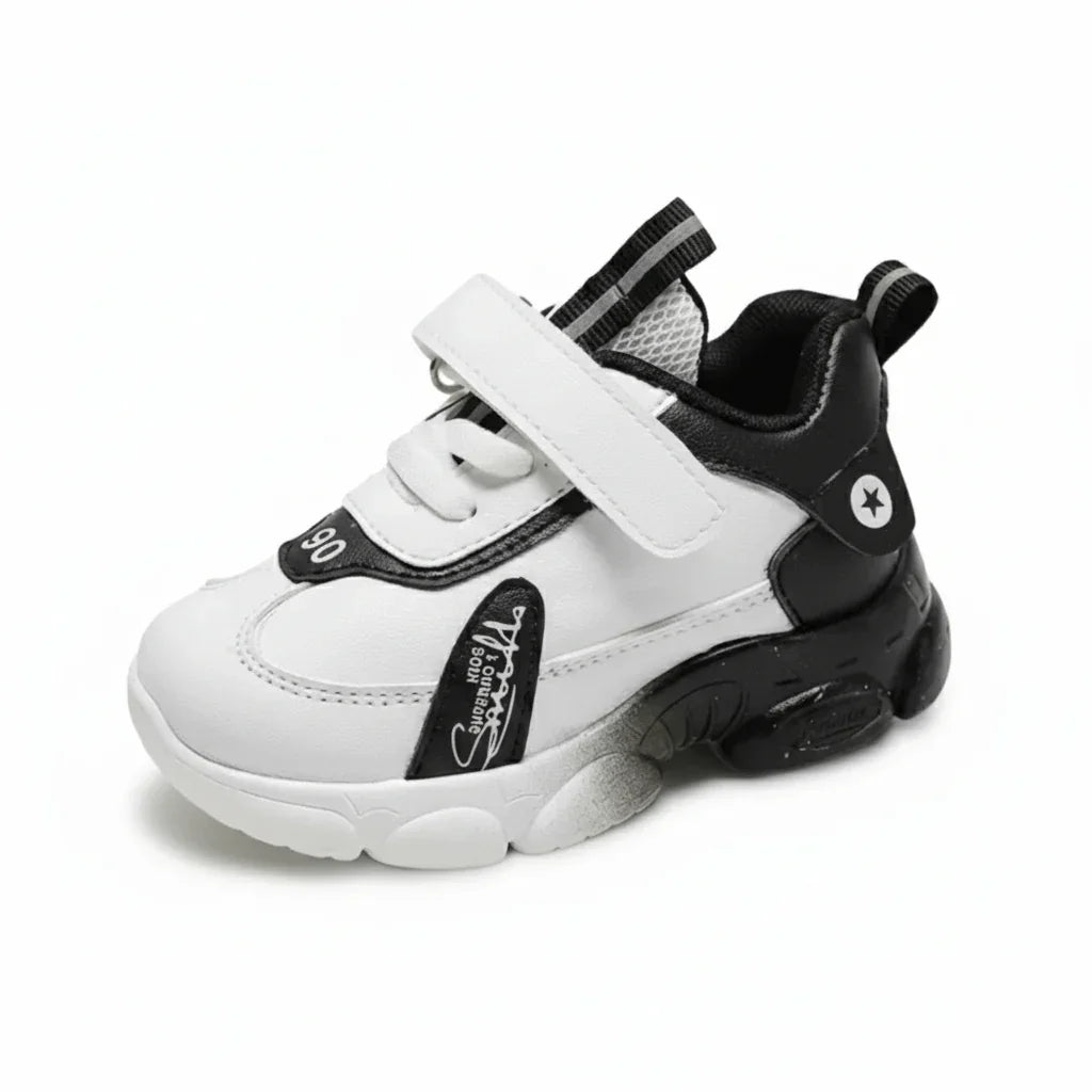 White and black high-top kids sneaker with Velcro strap and star logo on the heel