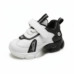 White and black high-top kids sneaker with Velcro strap and star logo on the heel