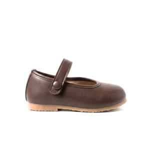 Brown leather Mary Jane shoe with buttoned strap and tan rubber sole on white background