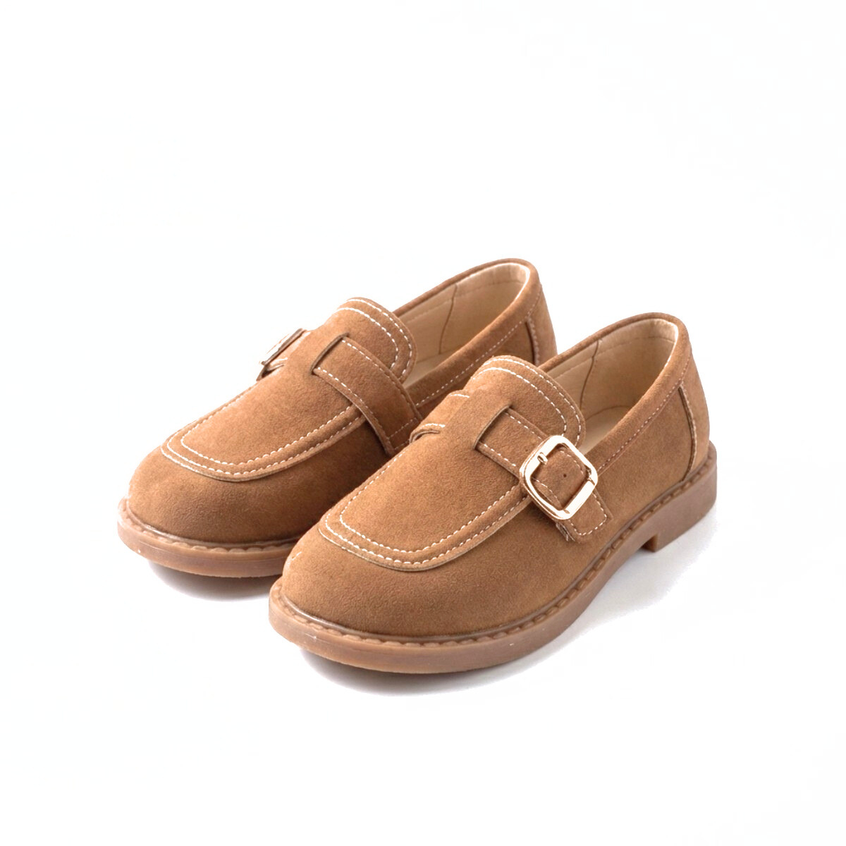 Pair of caramel brown suede kids loafers with gold buckle and stitching on white background