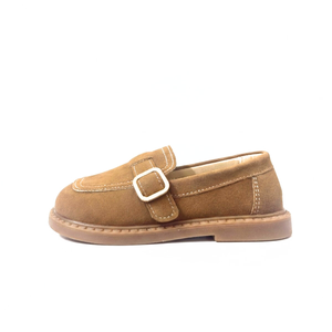 Caramel-colored kids suede loafers with buckle detail and stitched sole on white background