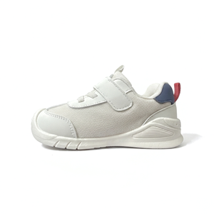 White sneaker with a red and blue accent on a white background