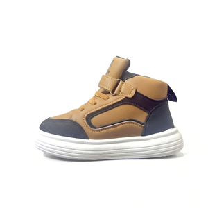 Tan and black kids mid-top sneaker with white sole on white background