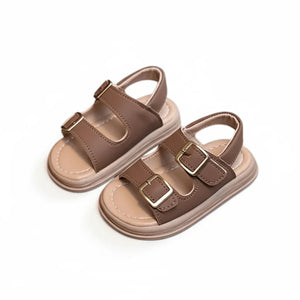 Brown kids sandals with adjustable buckles and cushioned soles on white background