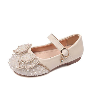 Elegant beige girls' party shoes with pearl and crystal bow embellishments and ankle strap