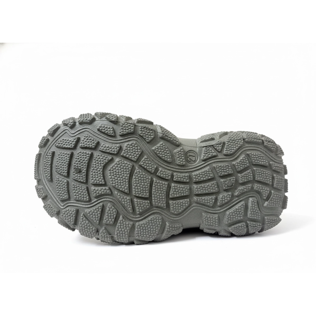 Close-up of rugged gray rubber outsole of kids' sneaker with deep tread for outdoor comfort