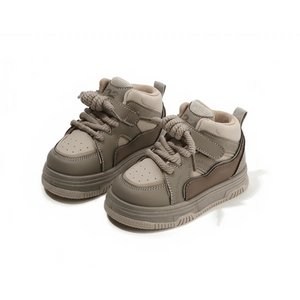Pair of brown high-top kids sneakers with thick soles and chunky laces on white background