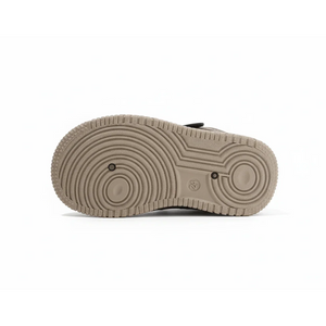 Beige high-top kids sneaker sole with textured circular grip pattern, size 24 visible