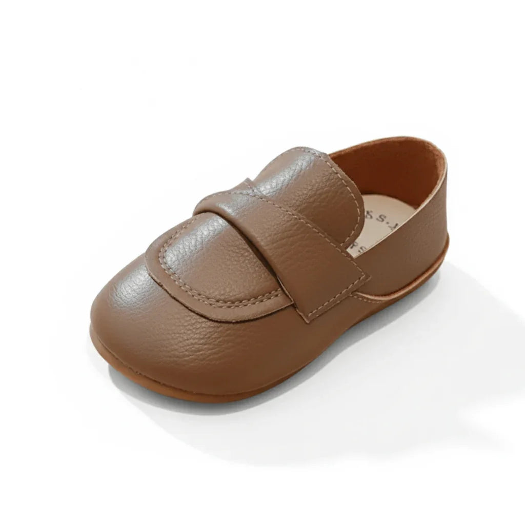 Classic brown leather baby loafer shoe with stitched details and rounded toe